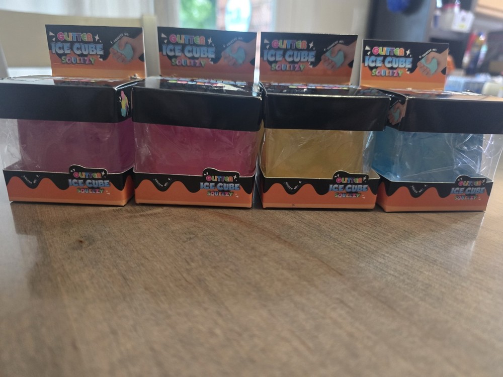 4 Glitter Ice Cube Squeezy Squishies. Blue, Yellow, Pink And Purple